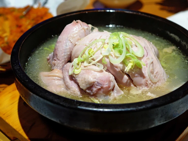 a close up of a bowl of food on a table, a picture, shin hanga, chicken, smooth shank, shin jeongho, bone