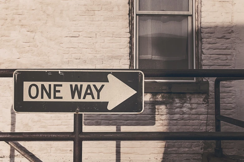 a one way sign in front of a brick building, pixabay, fine art, best on adobe stock, banner, looking down road, one line