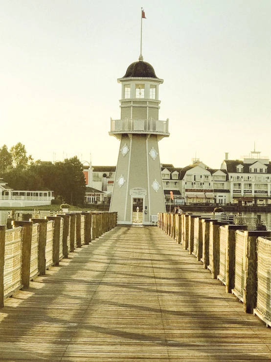 a light house sitting on top of a wooden pier, by Ryan Pancoast, flickr, art nouveau, disney land, midwest town, walkway, sunfaded