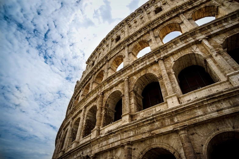 a view of the roman colossion under a cloudy sky, a portrait, shutterstock, side view intricate details, coliseum backdrop, low angle photography, brown