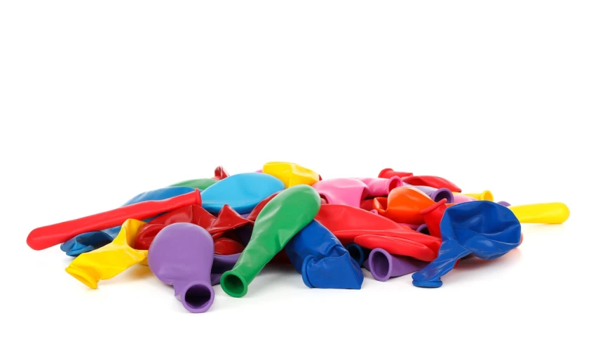 a pile of assorted plastic toys on a white surface, a stock photo, shutterstock, plasticien, hot air balloon, 4 0 years, fart, wide range of colors