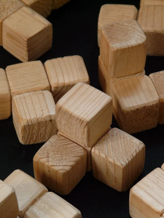 a pile of wooden blocks sitting on top of a table, flickr, photograph credit: ap, rolling dice, unfinished, 1/320