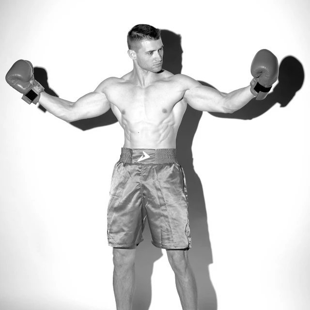 a black and white photo of a man with boxing gloves, fully body photo, commercial photo, athletic tall handsome guys, high res photo
