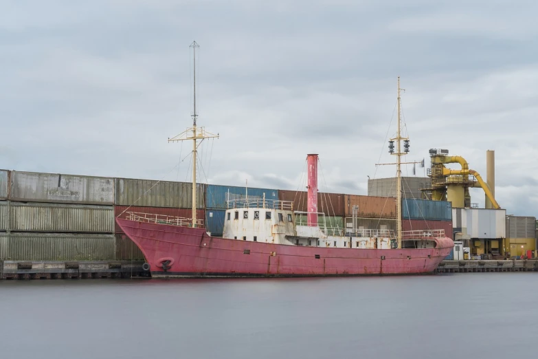 a large pink boat sitting on top of a body of water, by Richard Carline, old wooden ship, utilitarian cargo ship, set photo, victoria