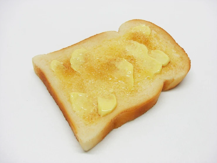 a piece of toast with butter on it, by Robert Peak, flickr, minimalism, shiny skin”, naoya tanaka, hut, australia