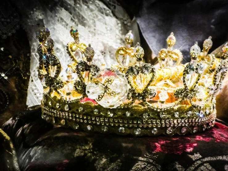 a close up of a crown on a pillow, by Maksimilijan Vanka, pexels, rococo, venice biennale's golden lion, veils and jewels, post processed, concert