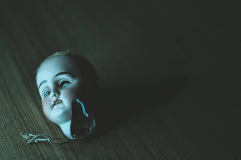 a small child laying on top of a wooden floor, a portrait, unsplash, massurrealism, evil dead face, the mekanik doll, 1800s photo of a deformed, dark scene with dim light