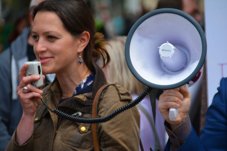 a woman holding a megaphone up to her ear, taken in the late 2010s, wikimedia commons, protest movement, avatar image