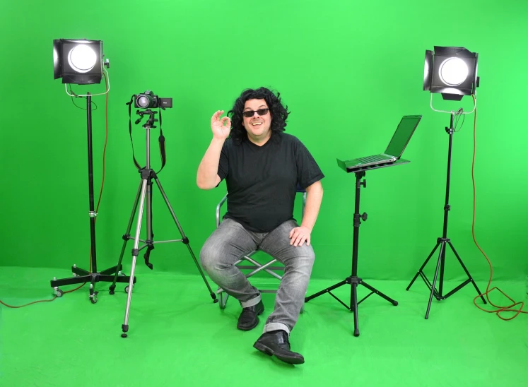 a man sitting on a chair in front of a green screen, a picture, chris chan, fullbody photo, tommy wiseau, product introduction photo