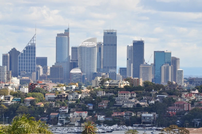 a view of a city from the top of a hill, inspired by Sydney Carline, shutterstock, hurufiyya, 7 0 mm photo, tony roberts, big buildings, 8 0 mm photo