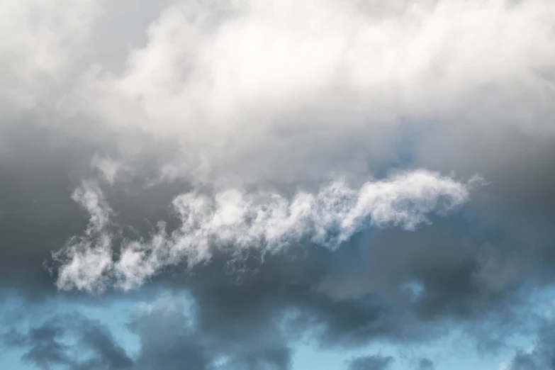 a large jetliner flying through a cloudy sky, a picture, by Etienne Delessert, precisionism, low angle 8k hd nature photo, mammatus clouds, middle close up shot, blue and gray colors