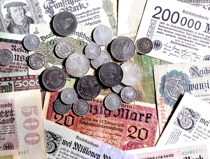 a pile of money sitting on top of a table, a photo, by Hans Fischer, pexels, art deco, set in ww2 germany, 1900s photo, istockphoto, medieval coin texture