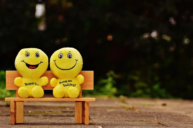 two yellow smiley faces sitting on a wooden bench, a picture, trending on pixabay, happening, plushie photography, with a beautifull smile, motivational, 😃😀😄☺🙃😉😗