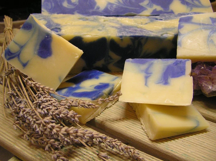 a bunch of soap sitting on top of a wooden cutting board, a picture, flickr, lavender fields in full bloom, cream and blue color scheme, made of cheese, swirl