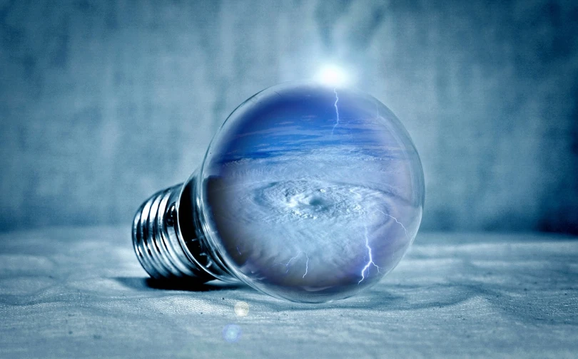 a light bulb sitting on top of a table, a picture, flickr, surrealism, realistic textured magnetosphere, with ice powers, thor, ffffound