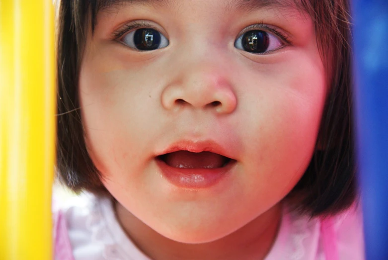 a close up of a child looking at the camera, a picture, japanese facial features, eyes wide opened, toddler, south east asian with round face