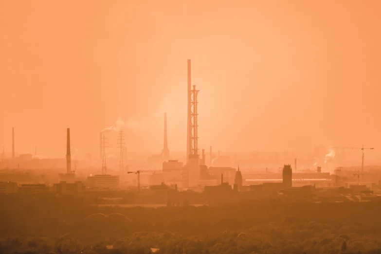 a large factory with a lot of smoke coming out of it, by Lee Loughridge, shutterstock, tonalism, pastel orange sunset, glasgow in background, duotone, reddish