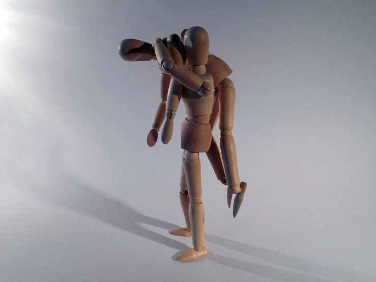 a wooden mannequin holding a tennis racquet in one hand and a tennis ball in the other, a surrealist sculpture, inspired by Oskar Schlemmer, hugging each other, full body 1 / 6 nihei tsutomu, dynamic action poses, making out