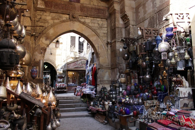 a market filled with lots of different types of items, egyptian art, pexels, hurufiyya, there are archways, in giza, ancient”, old town
