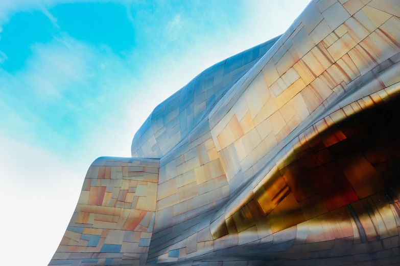 a close up of a building with a sky background, an abstract sculpture, inspired by Zaha Hadid, modernism, oregon, photo of a huge theaterstage, canyon, colorful tiled architecture