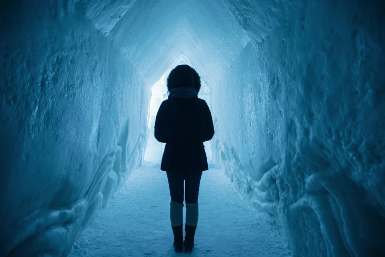 a woman standing in the middle of an ice tunnel, shutterstock, kramskoi 4 k, stock photo, endless hallways, freezing blue skin