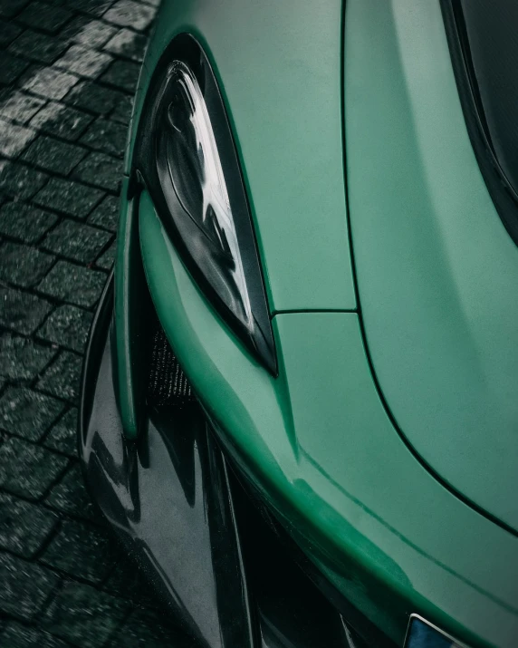 a close up of the front of a green sports car, a picture, by Matthias Weischer, unsplash, realism, mclaren, high body detail, bottom body close up, highly detaild 4k