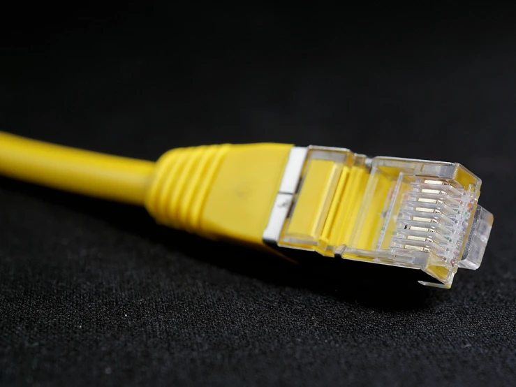 a close up of a yellow ethernet cable, a picture, by Richard Carline, pexels, rasquache, afp, oled, cake, wikimedia commons
