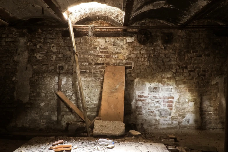 a room that has a wooden door in it, by Edward Corbett, down in the sewers of london, natural light beam, lost place photo, cold top lighting