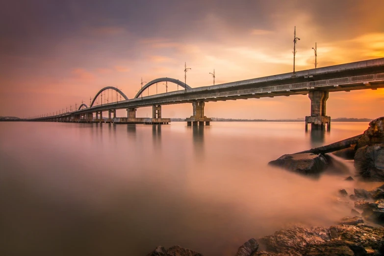 a long bridge over a body of water, a picture, by Joze Ciuha, pixabay contest winner, timelapse, soft morning light, electricity archs, hoang lap