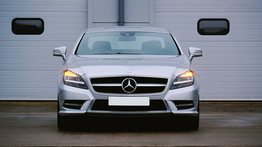 a car parked in front of a garage door, pixabay, photorealism, mercedez benz, front flash, istock, full head shot