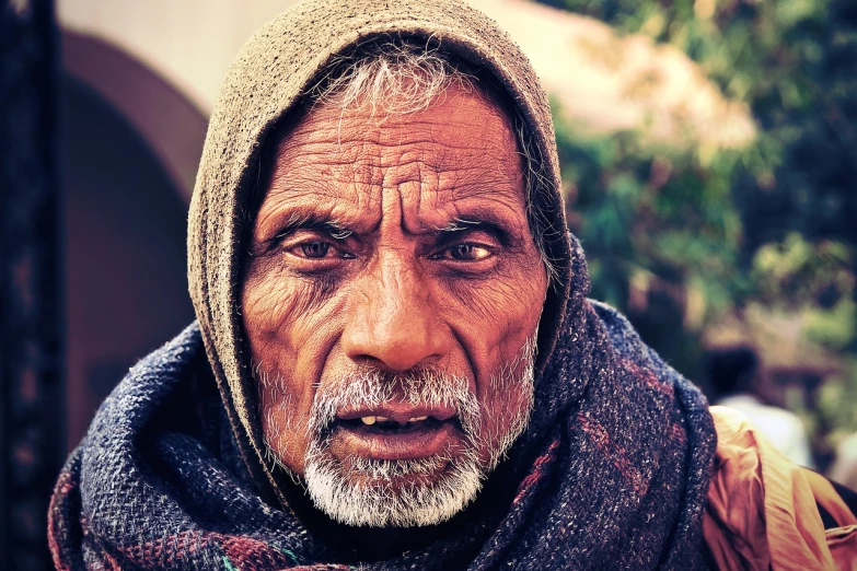 a close up of a person wearing a scarf, a character portrait, pexels contest winner, wise old indian guru, real human faces, skilled homeless, pretty face!!