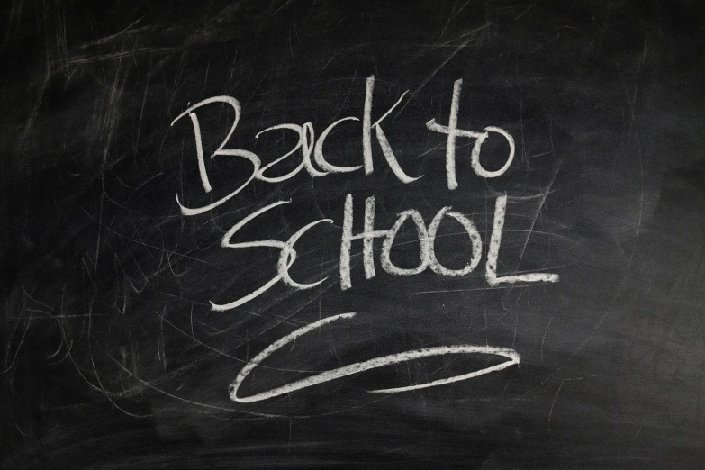 a blackboard with the words back to school written on it, high res photo