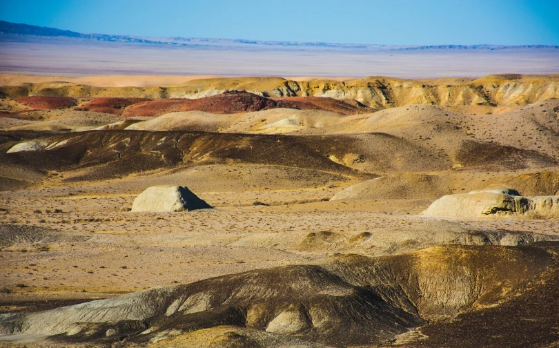 a person riding a horse through a desert, by Andrei Kolkoutine, shutterstock, color field, bisti badlands, high detail photo of a deserted, many small and colorful stones, stock photo