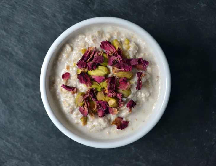 a bowl filled with oatmeal sitting on top of a table, by Alice Mason, hurufiyya, persian princess, natural point rose', sauce, subtle details