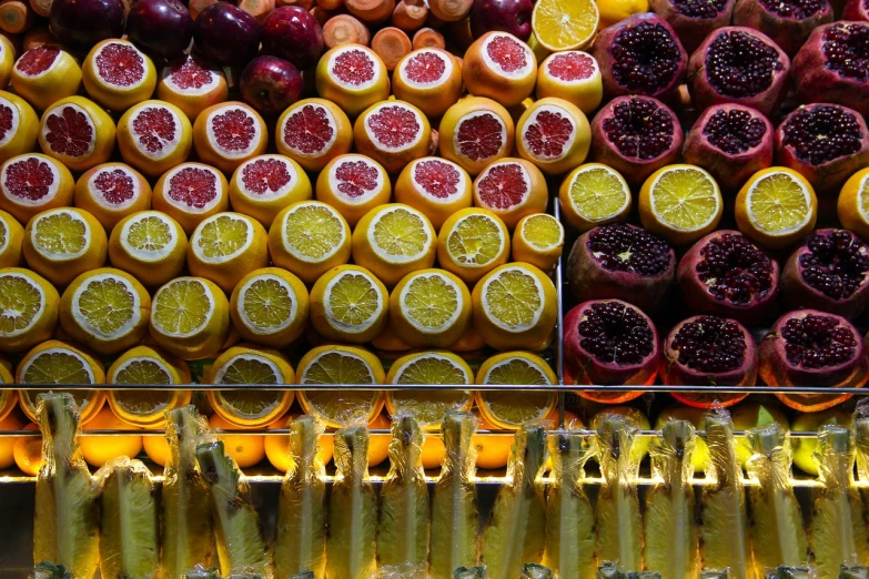 a display case filled with lots of different types of fruit, by Dietmar Damerau, process art, juice, yellow orange, glittering, holiday season