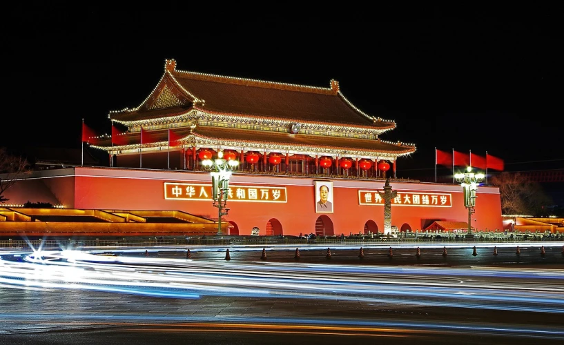 a chinese building is lit up at night, a picture, fine art, tiananmen square, award - winning photo. ”