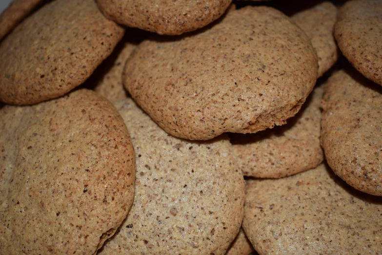 a pile of oatmeal cookies sitting on top of each other, inspired by Normand Baker, art nouveau, detailed zoom photo, flax, sleek round shapes, bangalore