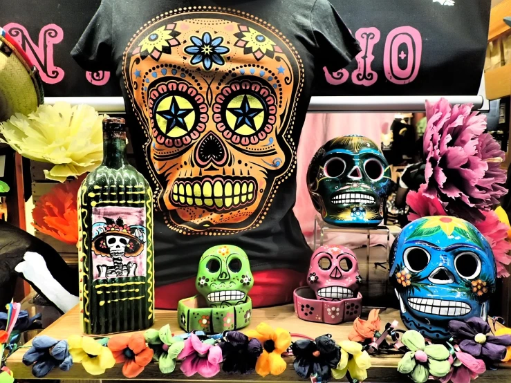 a group of sugar skulls sitting on top of a table, toyism, western clothing, band merchandise, mixed medias, store