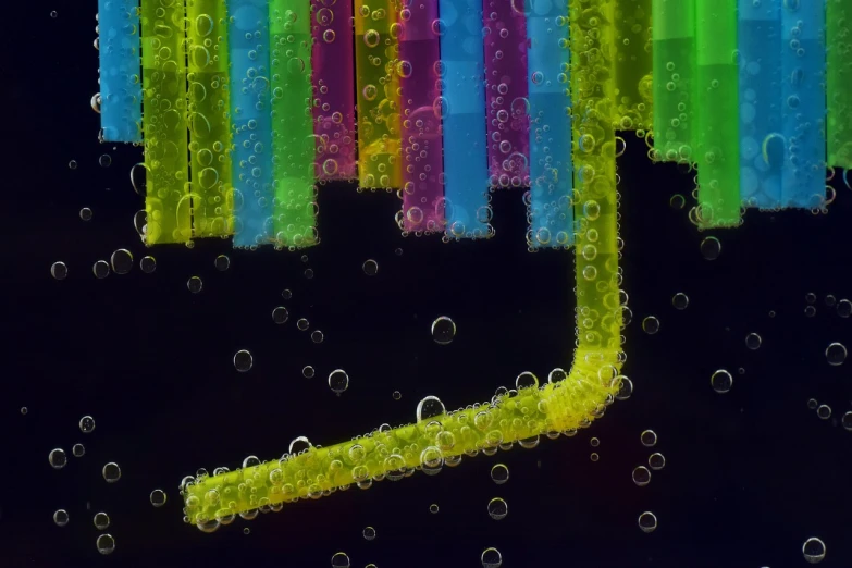 a close up of a toothbrush in a glass of water, a microscopic photo, by Jan Rustem, flickr, analytical art, neon pillars, with a straw, colorful city, bubbles ”
