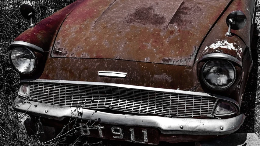 an old rusty car parked on the side of the road, a photo, by Tom Carapic, trending on pixabay, photorealism, metal skin with some scratches, front flash, ford, red monochrome