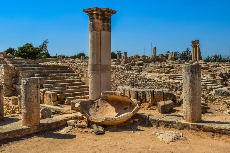 a stone bowl sitting on top of a pile of rubble, by Edward Ben Avram, shutterstock, romanesque, greek-esque columns and ruins, cyprus, very wide angle view, horned