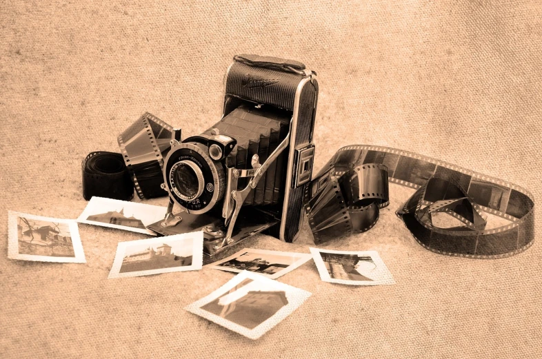 a black and white photo of an old camera, a polaroid photo, art photography, sepia, miscellaneous objects, 8k photo, on old paper