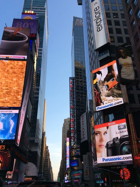 a city street filled with lots of tall buildings, a picture, electronic ads, standing in time square, shot from a low angle, annie leibowit