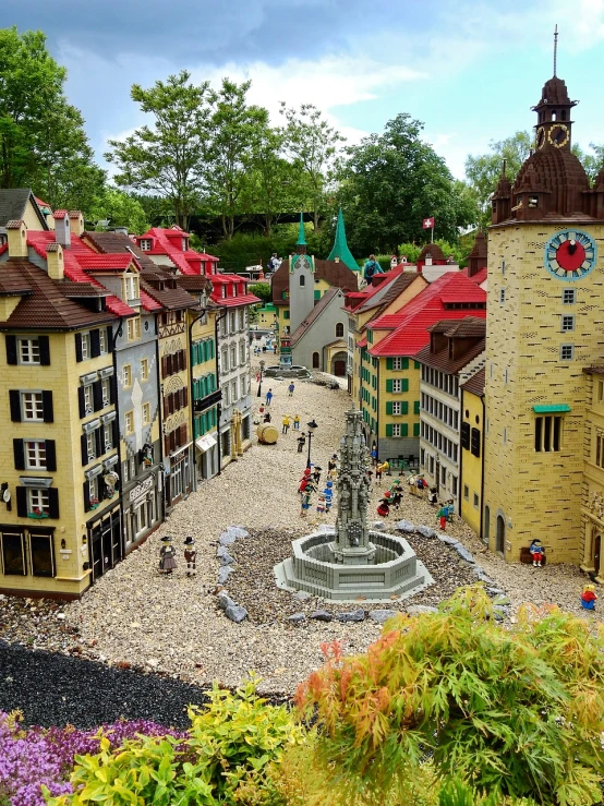 a small town with a fountain in the middle of it, inspired by Karl Stauffer-Bern, flickr, lego, photo taken in 2 0 2 0, detailed scenic view, summer day