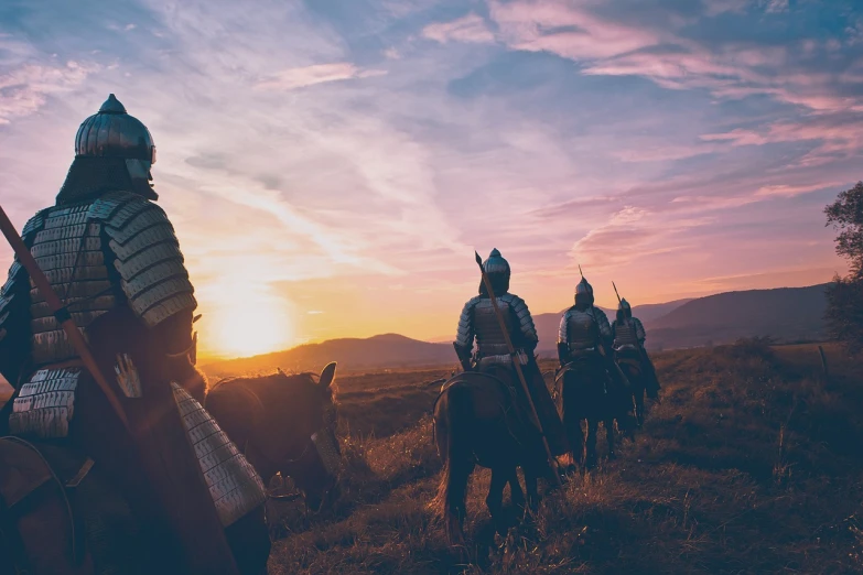 a group of people riding on the backs of horses, by Adam Marczyński, pexels contest winner, renaissance, looking out at a sunset, wearing armour, on a battlefield, istock