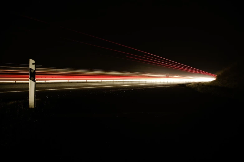 a long exposure photograph of a street at night, a picture, digital art, red tail lights, lines of energy, 4 k ], super long shot