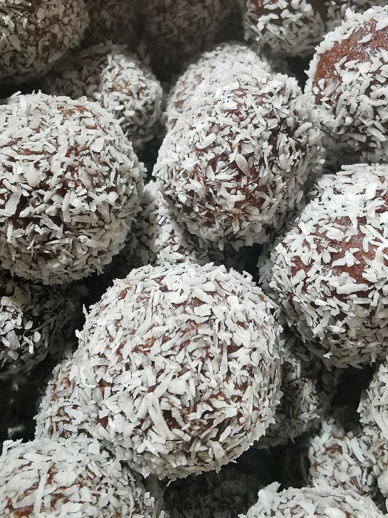 a pile of chocolate truffles sitting on top of each other, inspired by Ödön Márffy, hurufiyya, coconuts, highly detailed close up, planet hoth, fitness