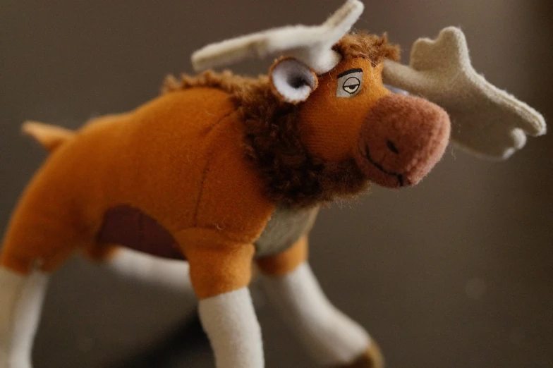 a close up of a stuffed animal on a table, by Jaakko Mattila, moose, micro detailed, simba, bottom angle