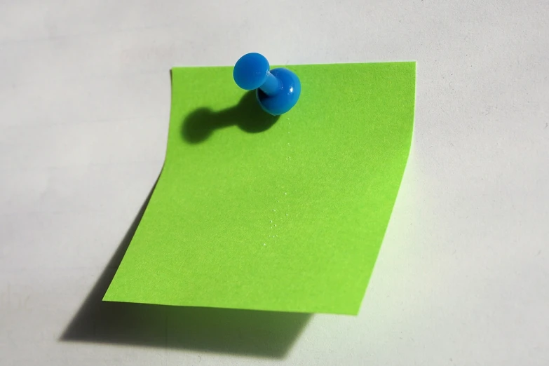 a blue push pin sitting on top of a green piece of paper, a photo, flickr, wall, well list, straw, on flickr in 2007