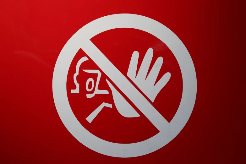 a close up of a sign on a red wall, a poster, by Robert Jacobsen, pixabay, hand instead of a face, stop sign, no face mask, shiny surfaces
